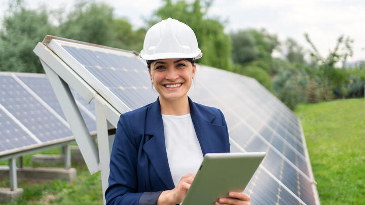 A Female Manager Engineer İn Safety Helmet Checking With Tablet An Operation Of Solar Panel System At Solar Station